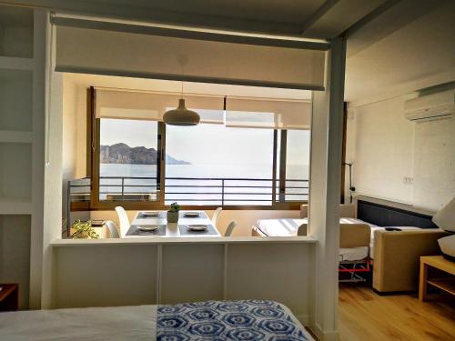 a room with a view of a balcony with a table at Apartamento Poniente Beach in Benidorm