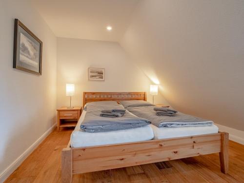 a bedroom with a large bed with a wooden frame at Westertilli 8 in Pellworm
