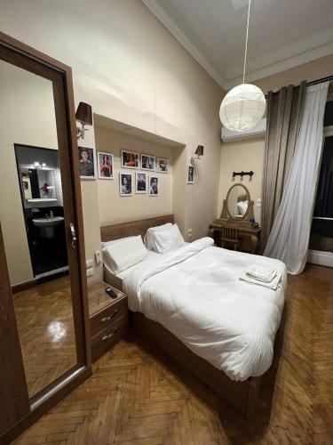 a bedroom with a large bed and a large mirror at Paris east in Cairo