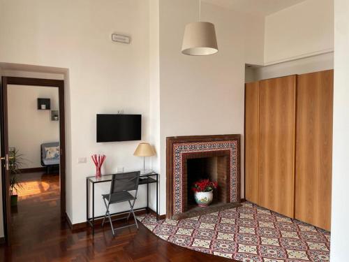 a living room with a fireplace and a television at Casa Giulia in Vietri sul Mare