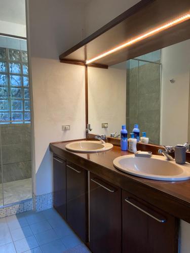 a bathroom with two sinks and a large mirror at Villa Virginia in Varese