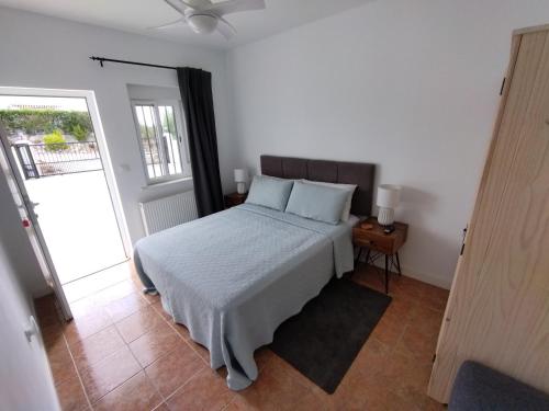 a bedroom with a bed and a door to a balcony at Immaculate Casa 2 bed 2 bath with pool Casa Oriana Oria Almeria in Oria