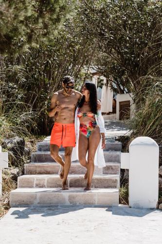 a man and a woman walking down some stairs at Can Vistabella Boutique Resort in San Antonio