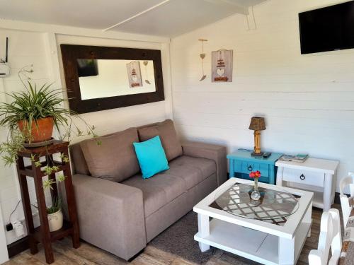 a living room with a couch and a table at Casa Lantana in Figueira da Foz