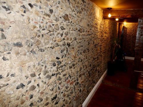 a stone wall in a room with a brick wall at Huge Luxury 8 Bed Manor House Hot Tub Pool Table in Saffron Walden