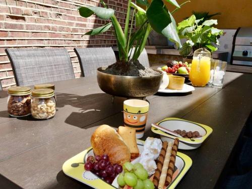 a table topped with plates of food and fruit at Huge Luxury 8 Bed Manor House Hot Tub Pool Table in Saffron Walden