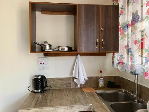 a kitchen with a sink and a counter top at Ahva I Residence in Jinja