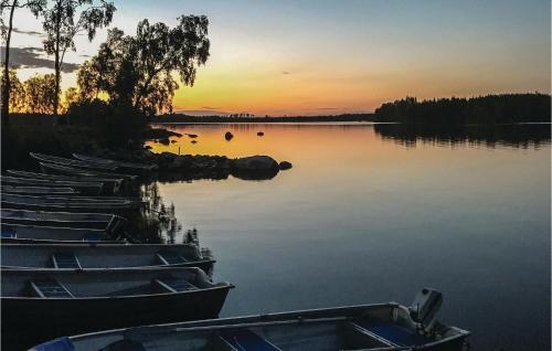 a group of boats on a lake at sunset at 3 Bedroom Lovely Home In Vittaryd in Kvänarp