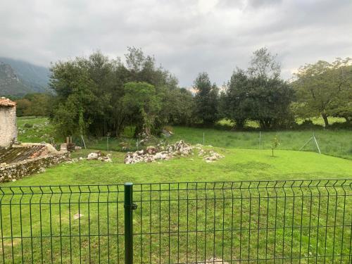 a group of rocks in a field behind a fence at Apartamentos Cañamal in Llanes