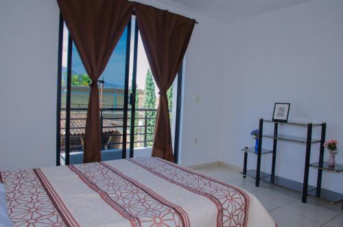 a bedroom with a bed and a balcony at Casa Blanca, Tlacolula in Tlacolula de Matamoros