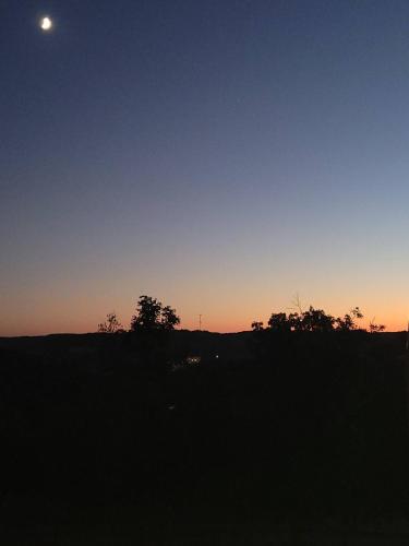 a sunset in a field with the moon in the sky at GREAT Little Guest Suite with Private Entry & Deck! Pet Friendly & 30 Mins to Nashville! in Ashland City