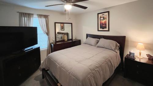 a bedroom with a bed and a flat screen tv at Pet-Friendly, GREAT Guest Suite with Private Entry & Deck! ONLY 25 Mins from Downtown Nashville! in Ashland City