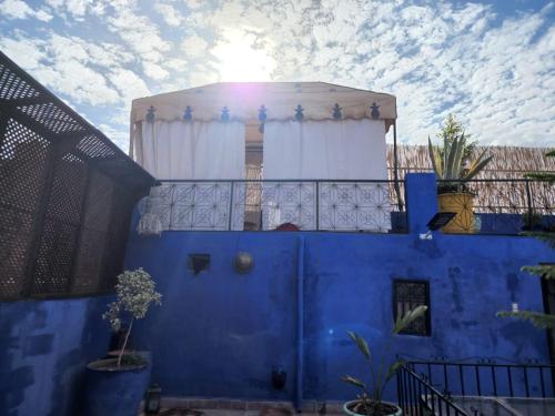 a blue building with a window and a balcony at RIAD GALIYA in Marrakech