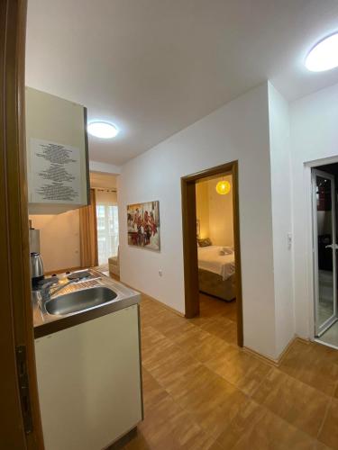 a room with a sink and a bedroom with a bed at Apartmens Xhenis Lux in Ulcinj
