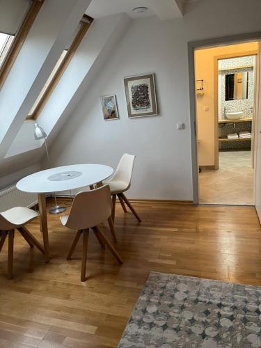 a dining room with a white table and chairs at Residence Sarka in Prague