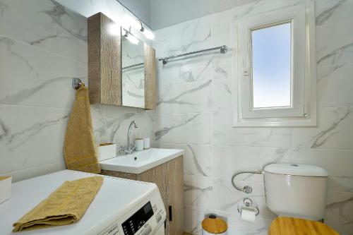 a white bathroom with a sink and a microwave at Gardenia Suite Corfu Town in Corfu