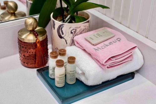 a bathroom counter with towels and a pile of towels at *New* Bourbon City Luxury Guest House in Louisville