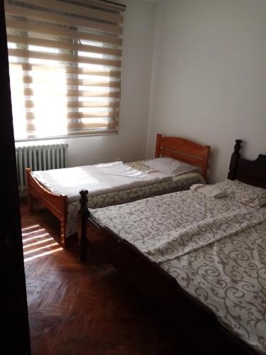 two twin beds in a room with a window at Kecman in Drvar