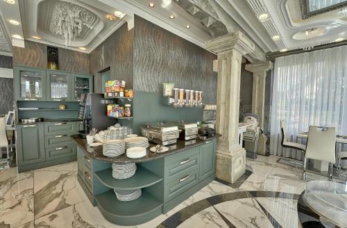 a kitchen with a counter with dishes on it at Vila Lemic Postojna in Postojna