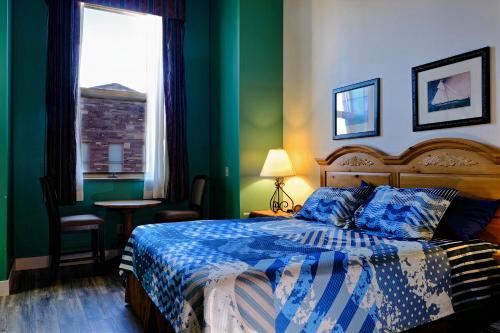 a bedroom with a bed with blue and green walls at Pet-friendly Canal Park Condonear Lakewalk Pool in Duluth