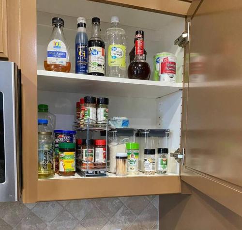 a cupboard filled with lots of bottles of alcohol at Hillside view with hot tub too in Arroyo Grande