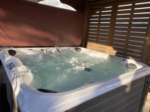 a jacuzzi tub with green water in it at Hillside view with hot tub too in Arroyo Grande