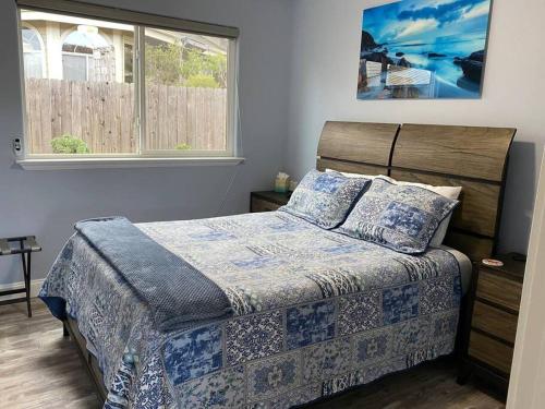 a bedroom with a bed and a window at Hillside view with hot tub too in Arroyo Grande