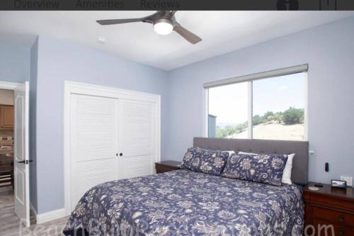 a bedroom with a bed and a ceiling fan at Hillside view with hot tub too in Arroyo Grande