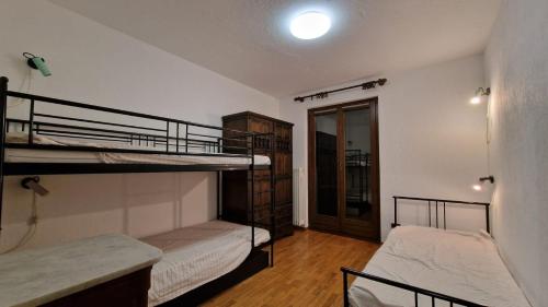 a room with two bunk beds and a hallway at Casa Sole in Morgex