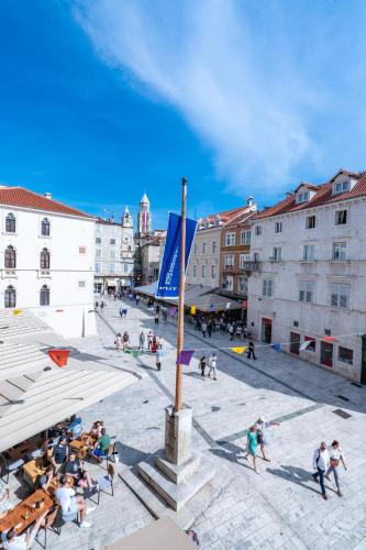 a group of people walking around a city square at Luxury Rooms Lucija and Luka in Split