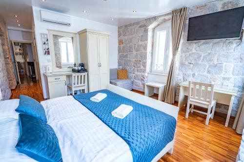 a bedroom with a large bed with a blue blanket at Luxury Rooms Lucija and Luka in Split