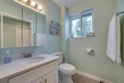 a bathroom with a sink and a toilet and a mirror at Bellevue Abode Balcony, 13 Mi to Downtown Seattle in Bellevue