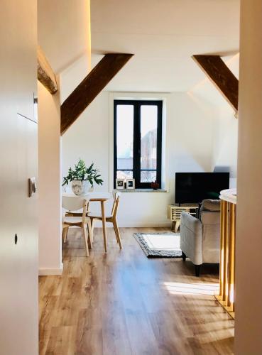 a living room with a table and a couch at Lobo do Mar Matosinhos Beach Loft in Matosinhos