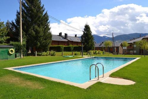 a swimming pool in the yard of a house at Ático en Llivia in Llivia