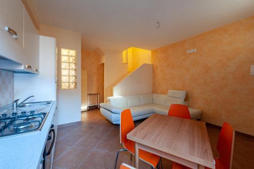 a kitchen and dining room with a table and a couch at Gratteri Holiday Appartamento Rapi Pitittu in Gratteri