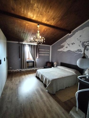 a bedroom with a bed and a wooden ceiling at Grace House in Cuglieri