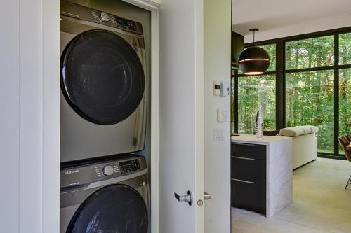 two washing machines are hanging on a wall in a room at Nature's Paradis Chalets by Rcnt Chalets in Lac-Superieur