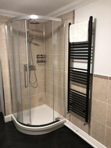 a shower with a glass enclosure in a bathroom at Ida House in Ormesby