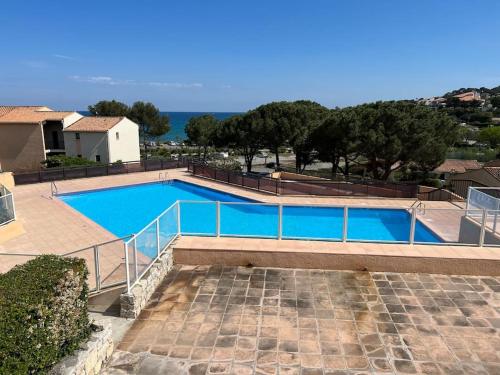 a swimming pool with blue water in a house at La Gaillardine T2+mezzanine 35m2 in Roquebrune-sur-Argens