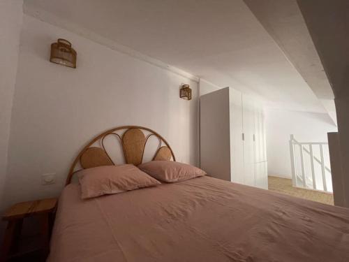 a bedroom with a large bed in a white room at La Gaillardine T2+mezzanine 35m2 in Roquebrune-sur-Argens