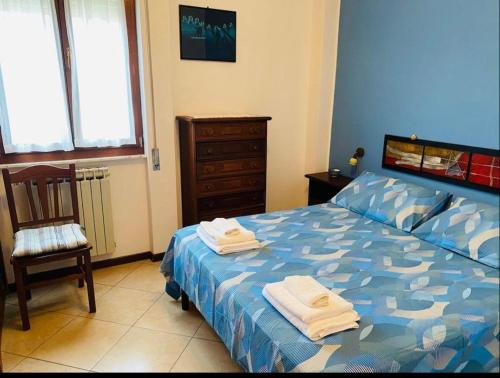 a bedroom with a bed with towels on it at Lovely Marinella in Marinella di Sarzana
