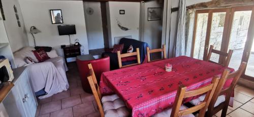 a dining room with a red table and chairs at THE BARN, MAISON, PISCINE PRIVATIVE, CALME, WIFI in Carayac