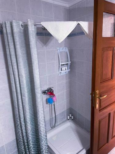 a shower in a bathroom with a shower curtain at Symi Breeze villa in Symi