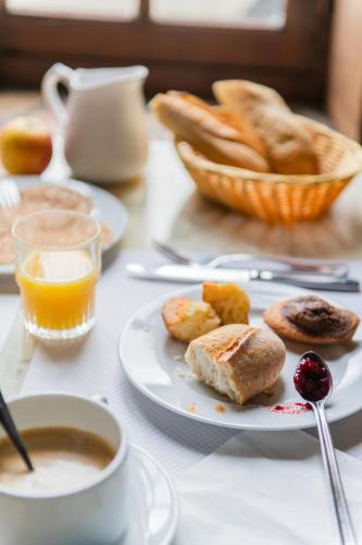 a table with plates of food and a cup of coffee at Le Relais Des Templiers in Beaugency