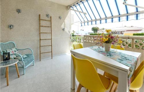 a room with a table and chairs on a balcony at Cozy Apartment In Vinaroz With Kitchen in Vinaròs