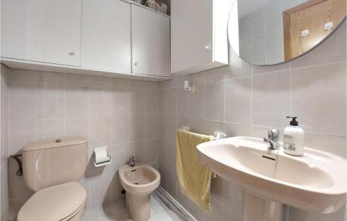 a bathroom with a toilet and a sink and a mirror at Cozy Apartment In Vinaroz With Kitchen in Vinarós