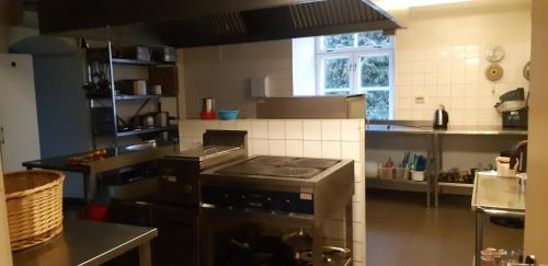 a kitchen with a stove top oven in a kitchen at Pärnu-Jaagupi pastoraat in Pärnu-Jaagupi
