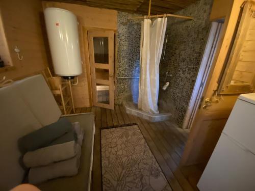 a view of a bathroom with a shower and a couch at Mooni Cottage in Pärnu