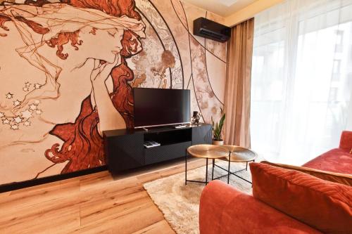 a living room with a wall mural of a woman at PORT19 in Wrocław