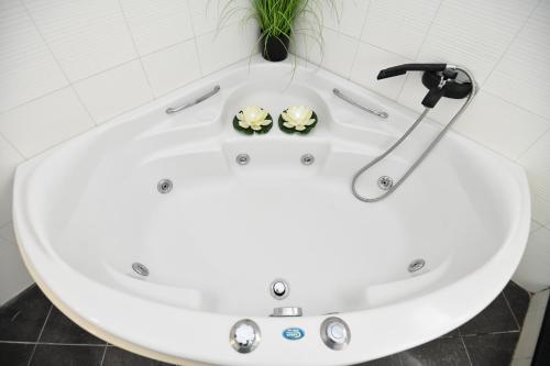 a white bath tub with two frog heads in it at Eva's Garden House in Ialyssos